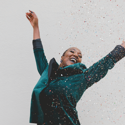 woman happily celebrating with confetti